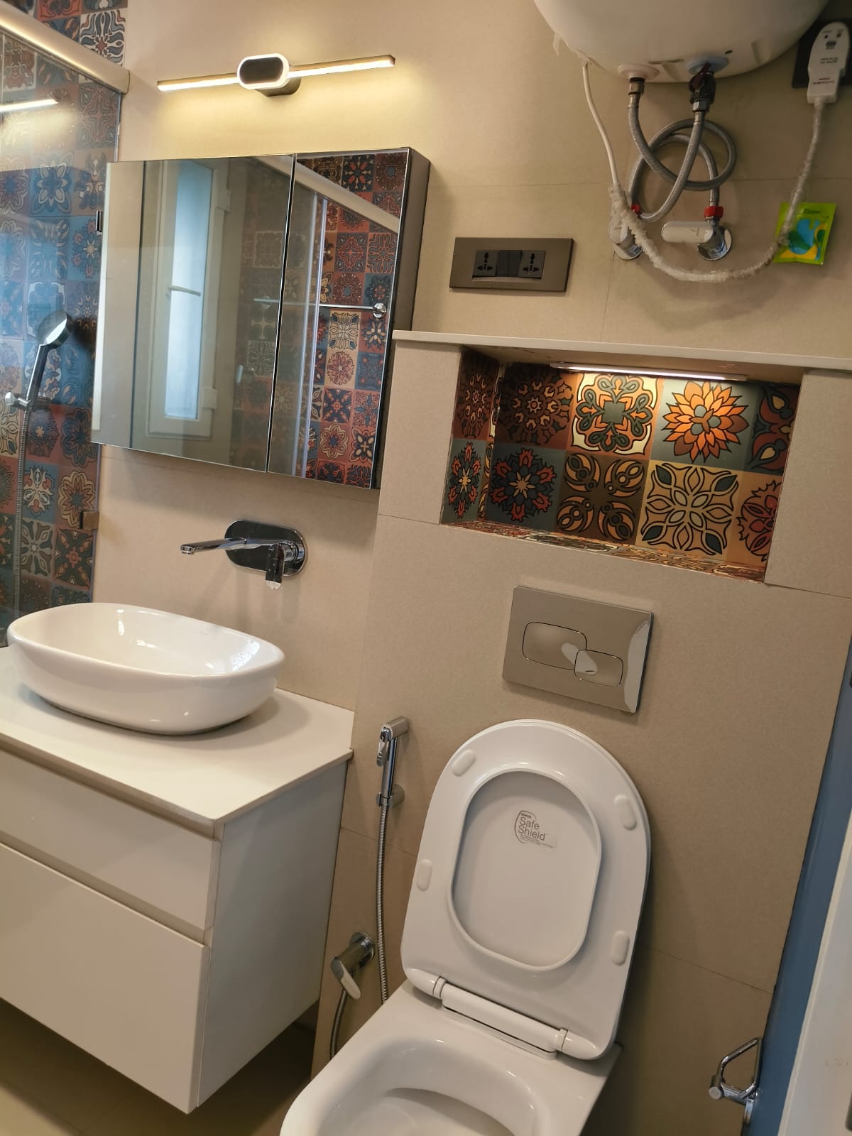 Bathroom with vessel sink, wall-hung WC and geyser plumbing fittings