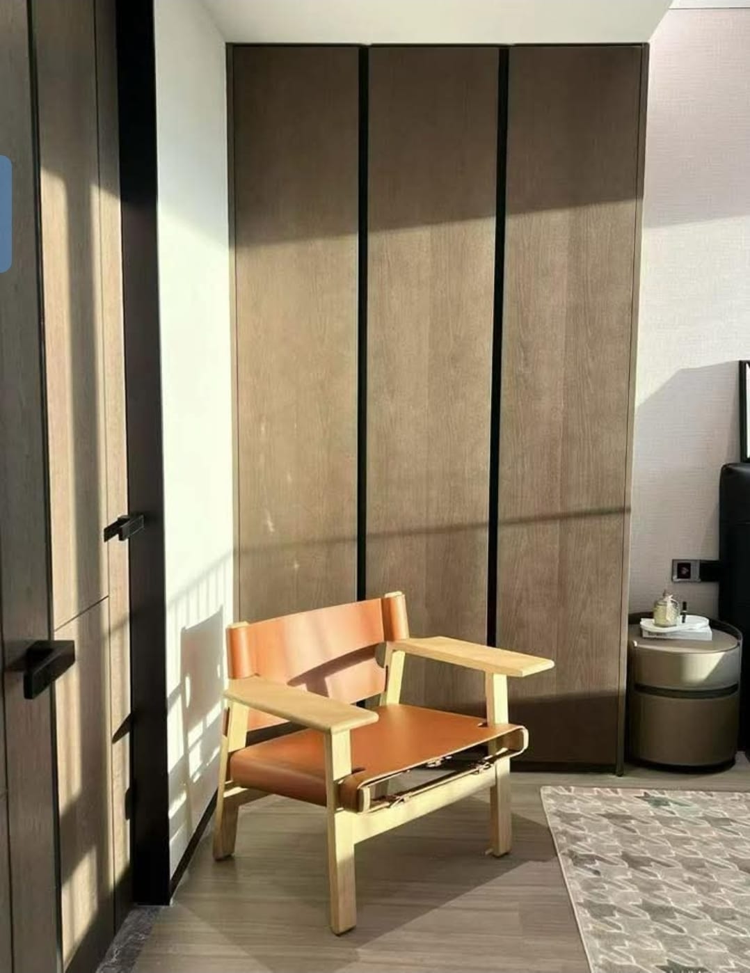 Bedroom with wooden wardrobe shutters and custom armchair